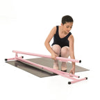 Woman using a pink balance beam on a white background