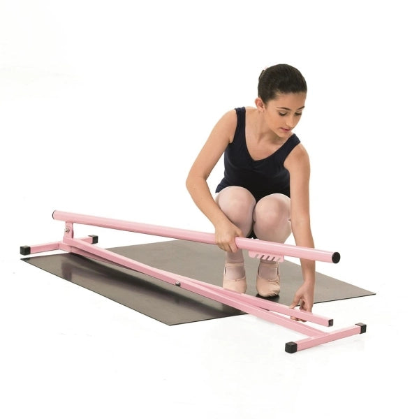 Woman using a pink balance beam on a white background