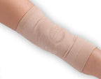Beige compression bandage on a person's leg against a white background