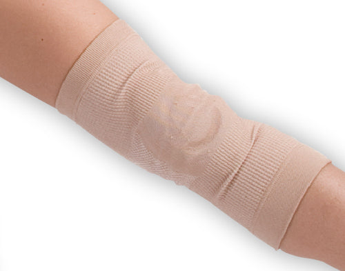 Beige compression bandage on a person's leg against a white background