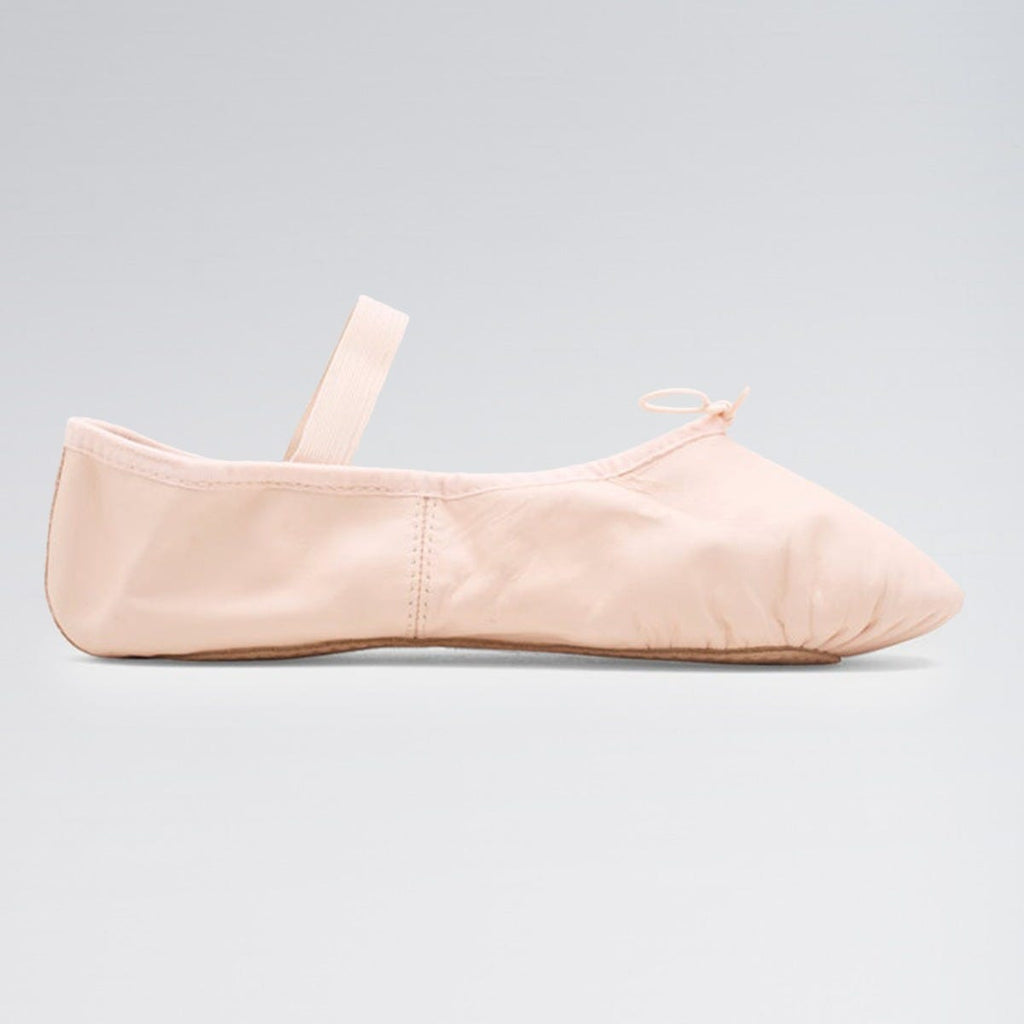 Beige ballet shoe on a light gray background