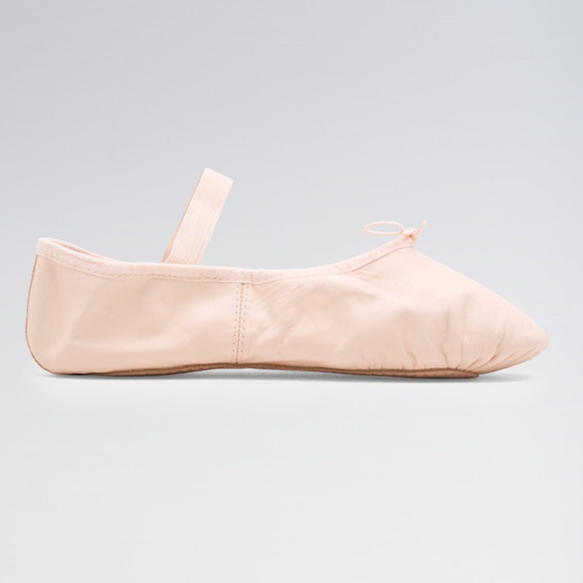 Beige ballet shoe on a light gray background