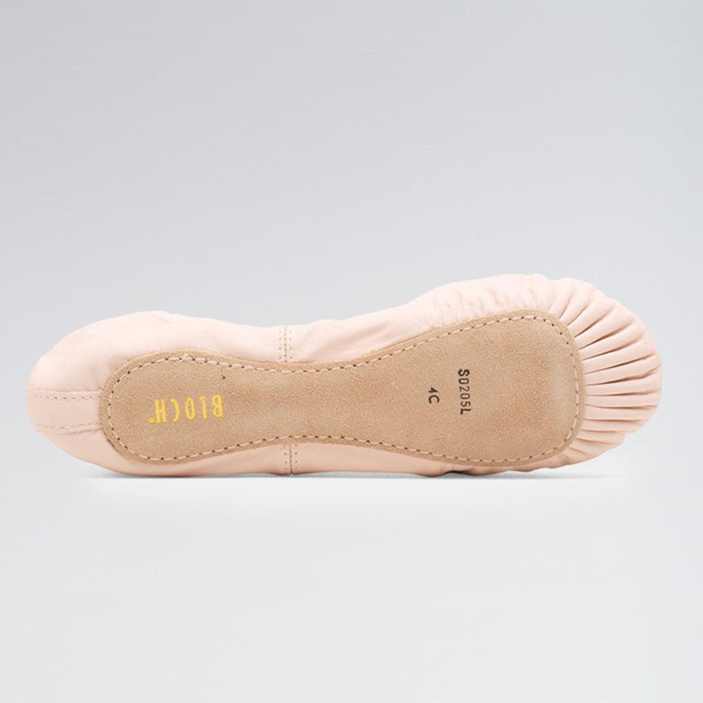 Ballet shoe with beige insole on a gray background