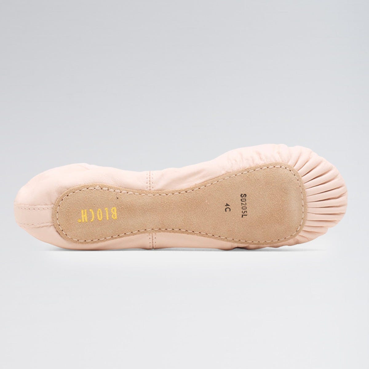 Ballet shoe with beige insole on a gray background