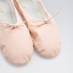 Pair of pink ballet shoes on a light gray background