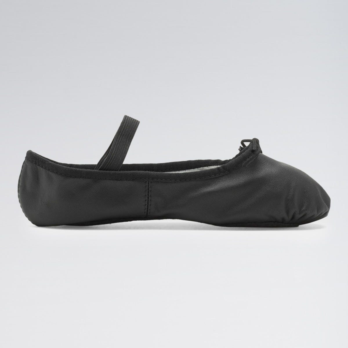 Black ballet shoe on a light gray background