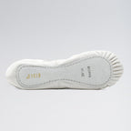 White ballet shoe sole with brand name on a light gray background