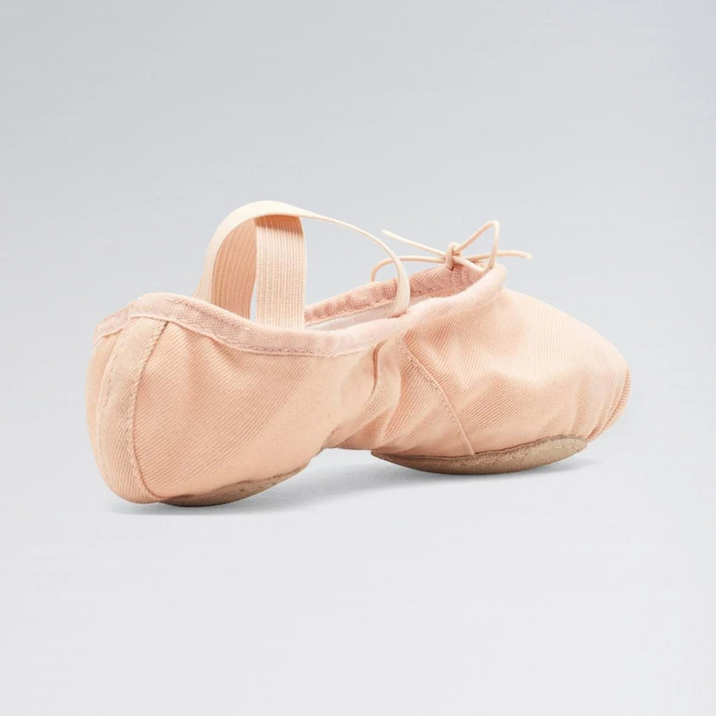 Pair of pink ballet shoes on a light gray background