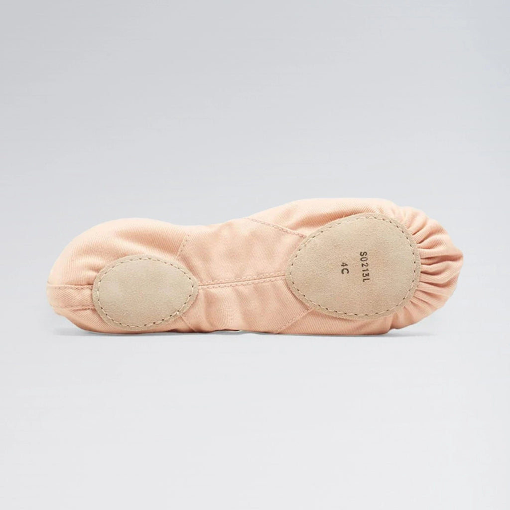 Pink ballet slipper with beige soles on a light gray background