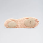 Pink ballet slipper with beige soles on a light gray background