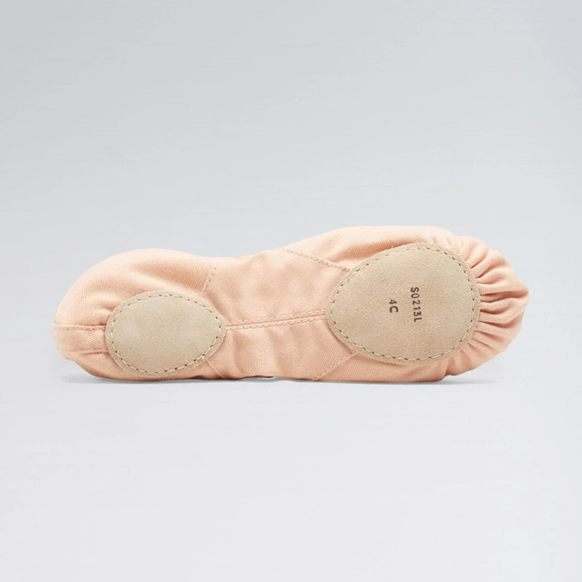 Pink ballet slipper with beige soles on a light gray background