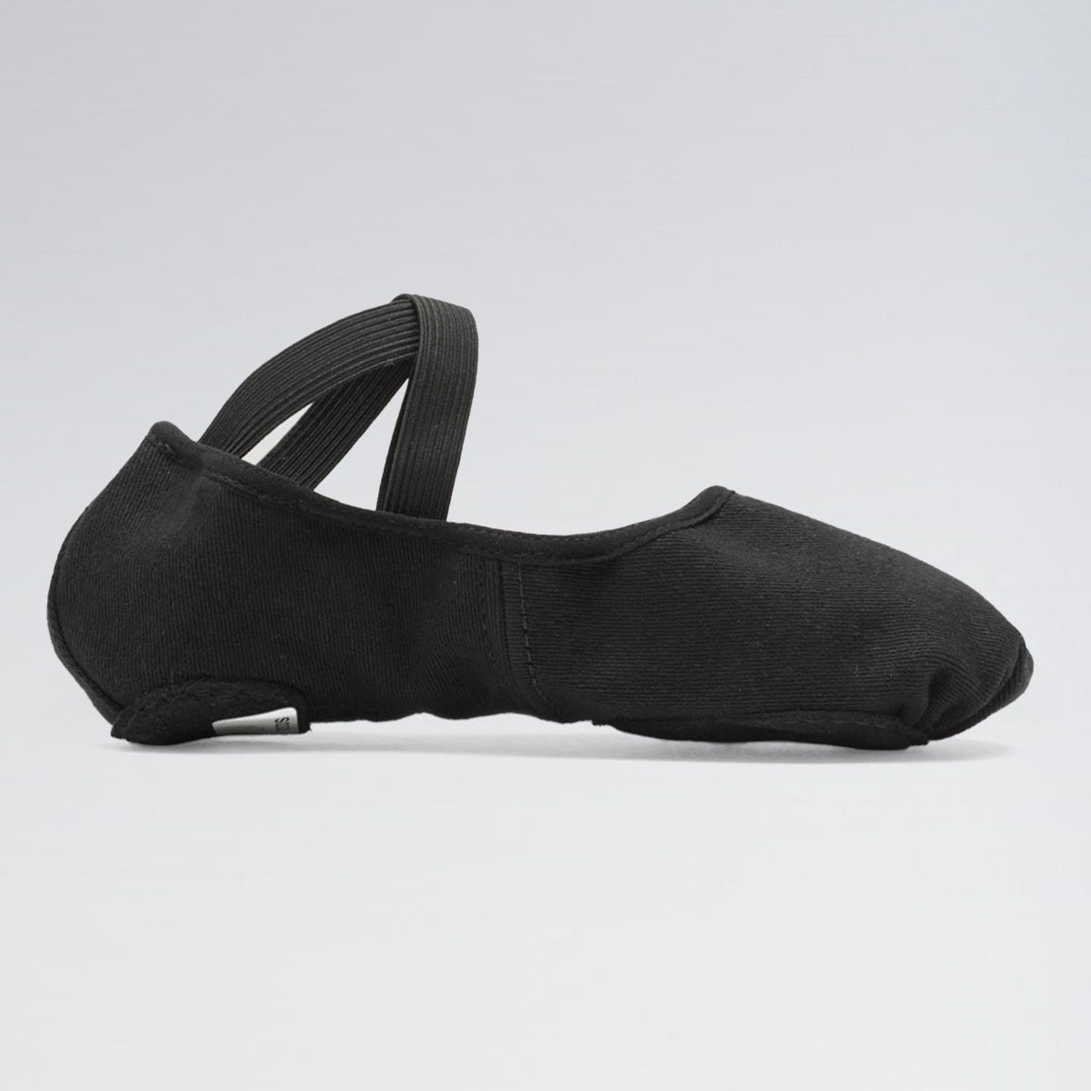 Black ballet shoe on a light gray background