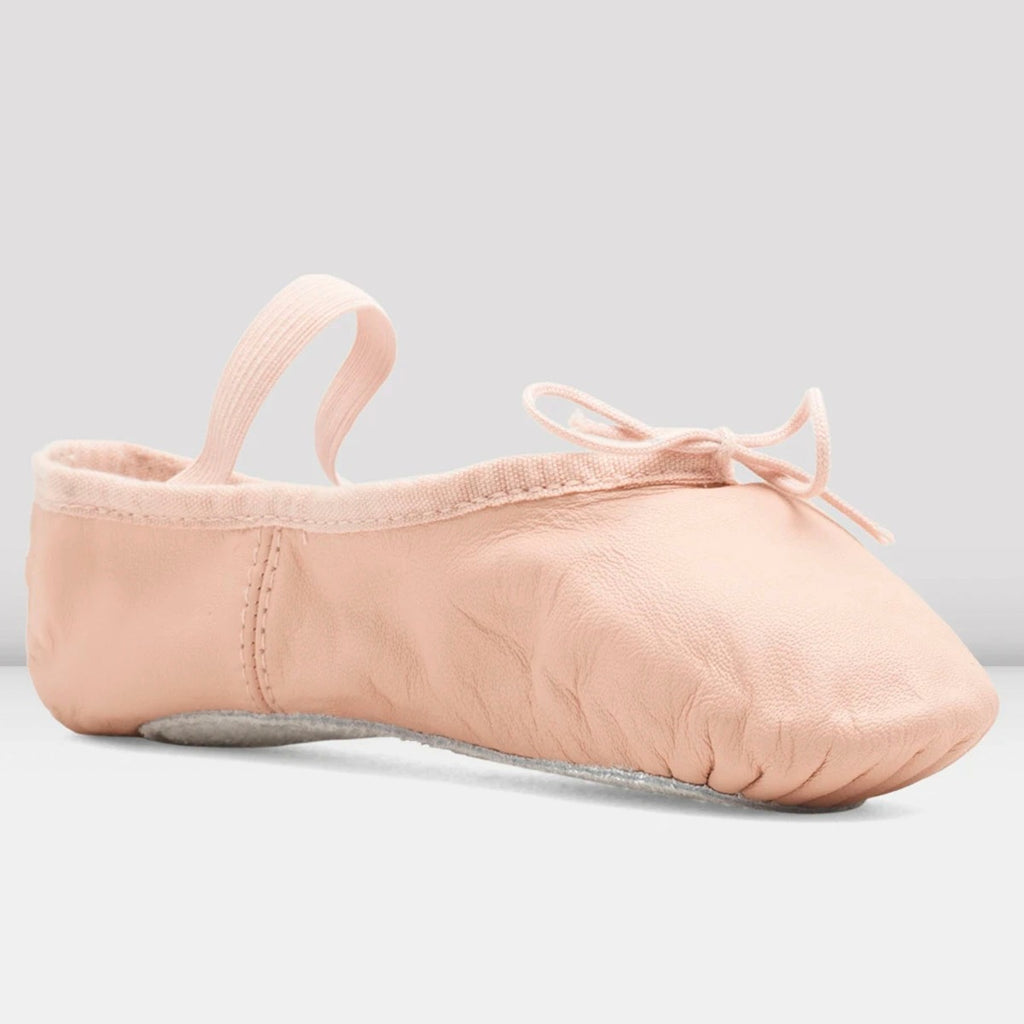Pink ballet shoe on a light gray background