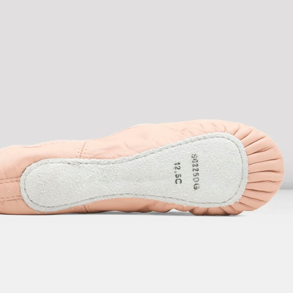 Close-up of a ballet shoe with a light gray sole on a white background