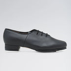 Black tap dance shoe on a gray background