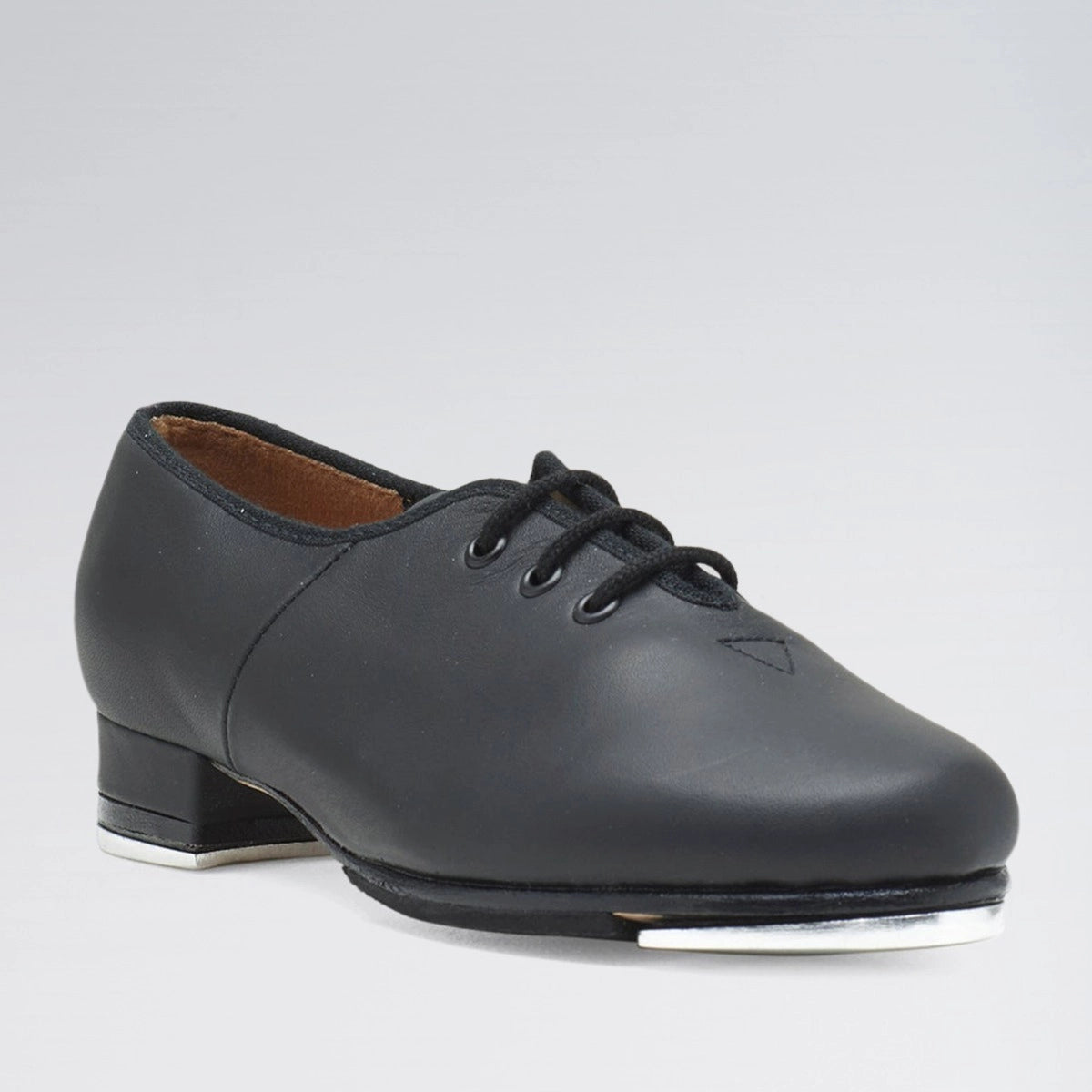 Black tap shoe on a gray background