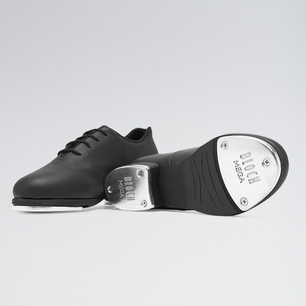 Black tap dance shoe with metallic toe on a light gray background