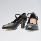 Black high-heeled shoes with strap on a light gray background