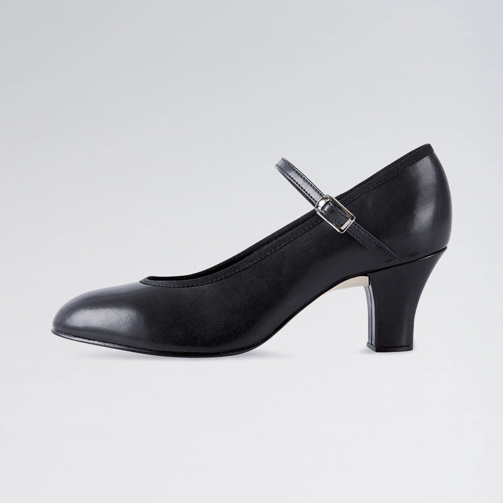 Black shoe with a strap on a light gray background