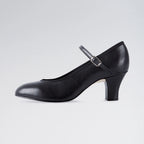 Black shoe with a strap on a light gray background