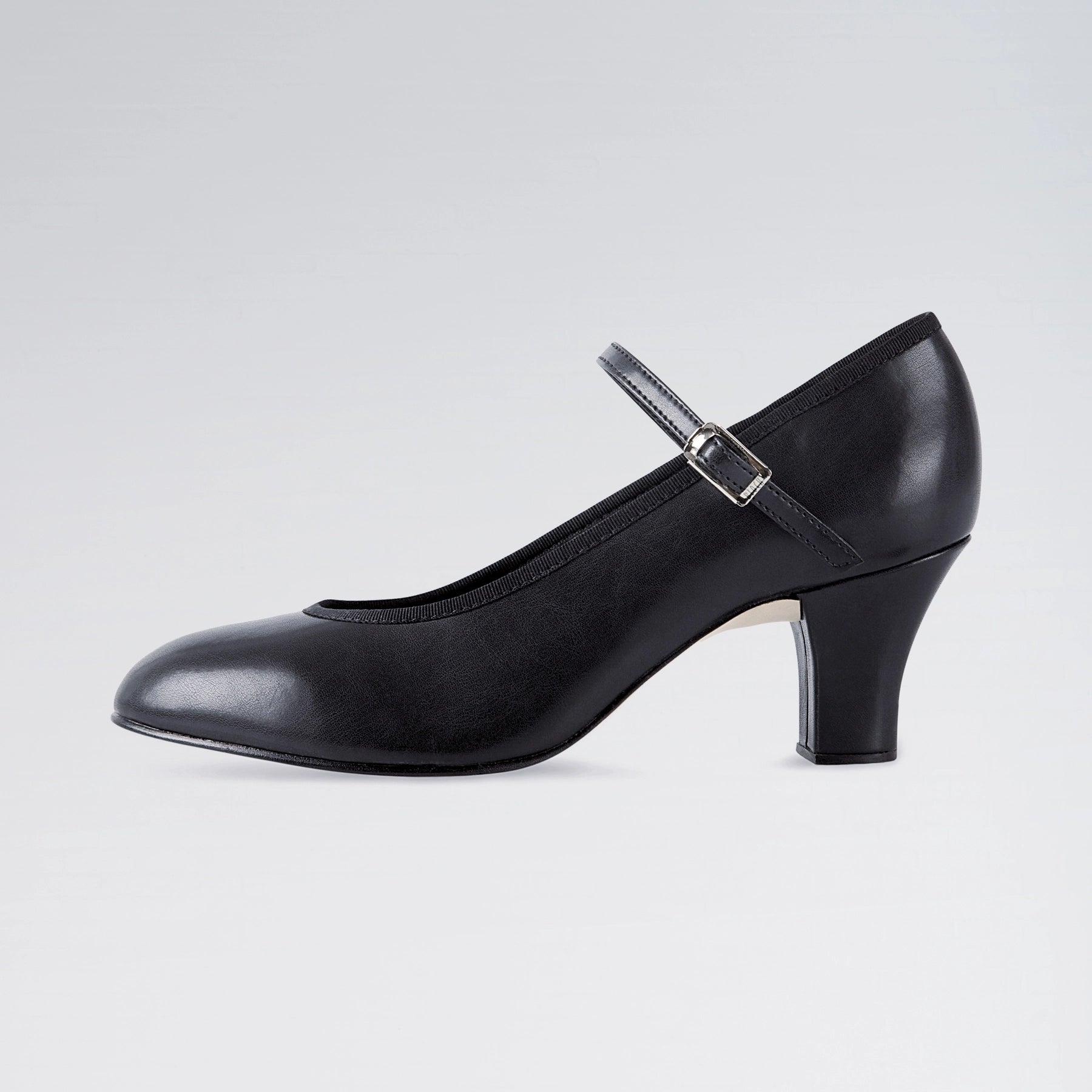 Black shoe with a strap on a light gray background