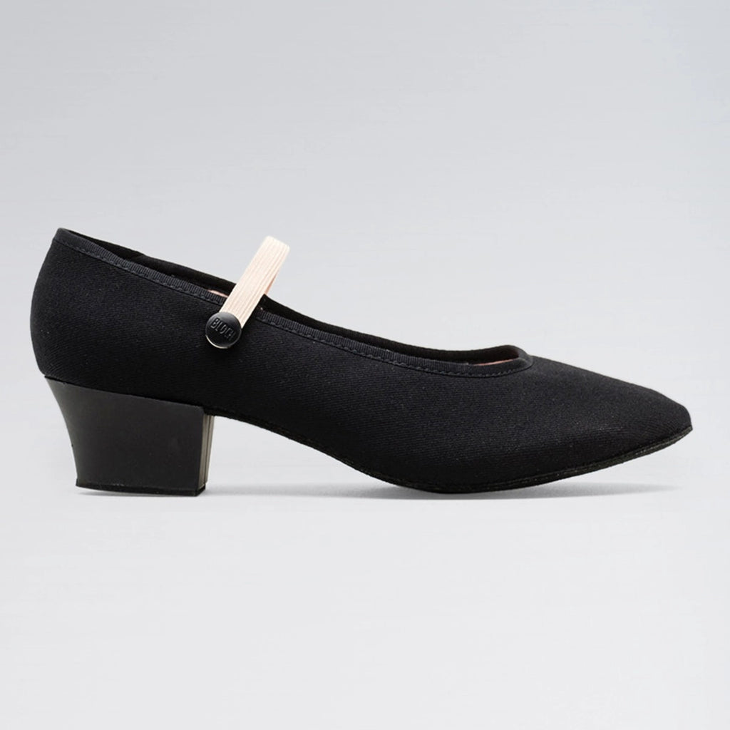 Black shoe with a small white object attached on a gray background