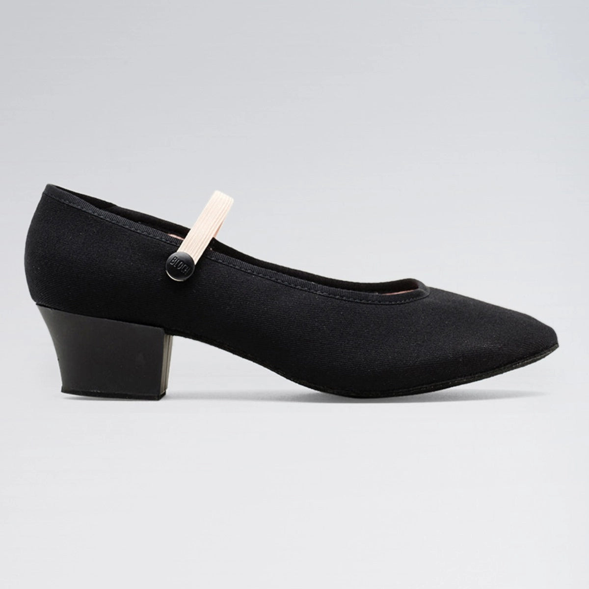 Black shoe with a small white object attached on a gray background