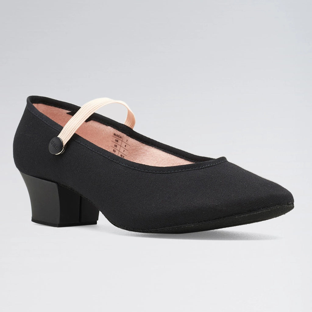 Black shoe with a block heel on a gray background