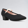 Black shoe with a block heel on a gray background