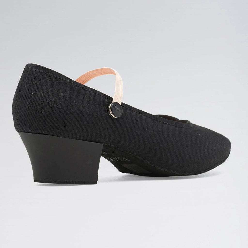 Black shoe with a block heel on a light gray background