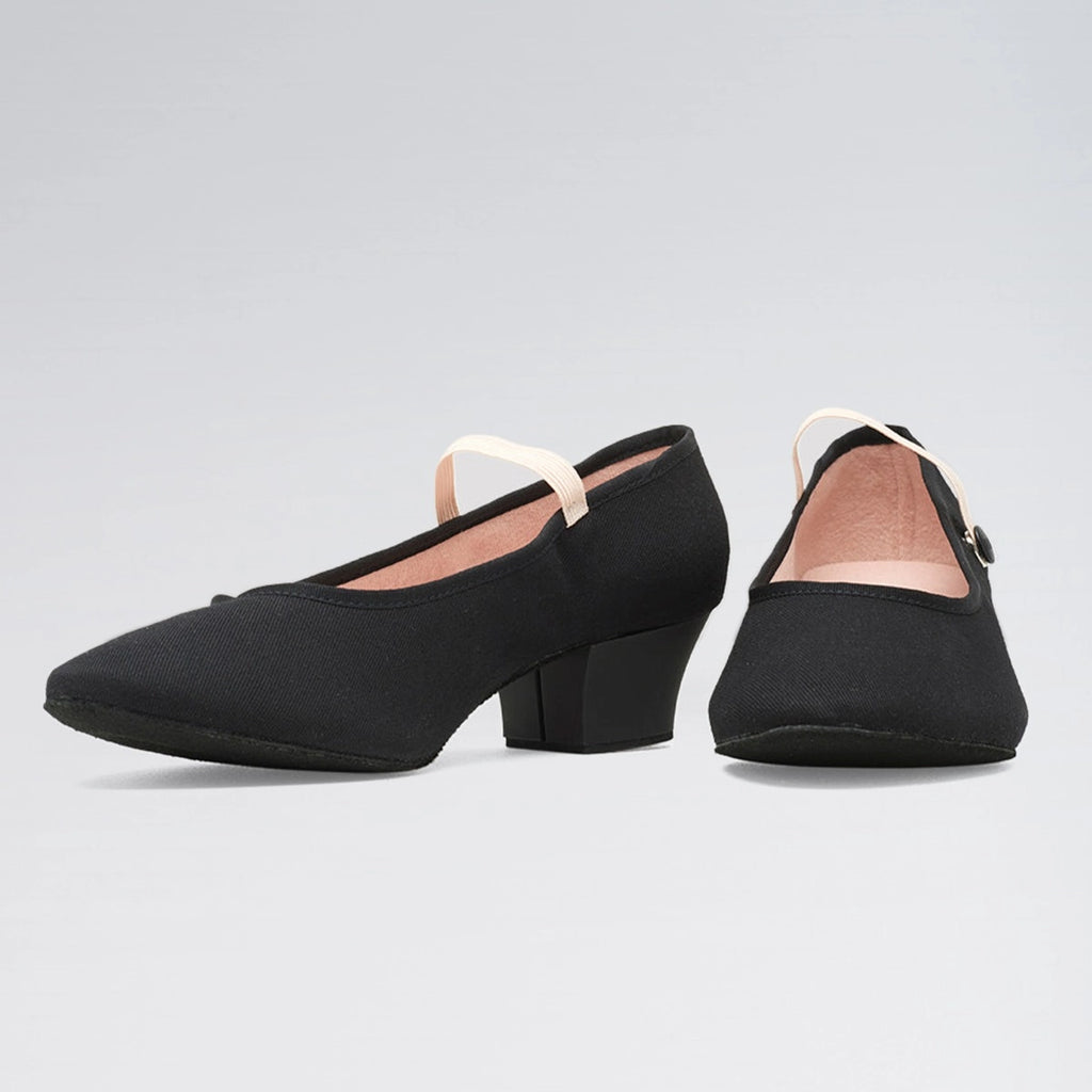 Black block-heel shoes on a light gray background