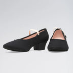 Black block-heel shoes on a light gray background