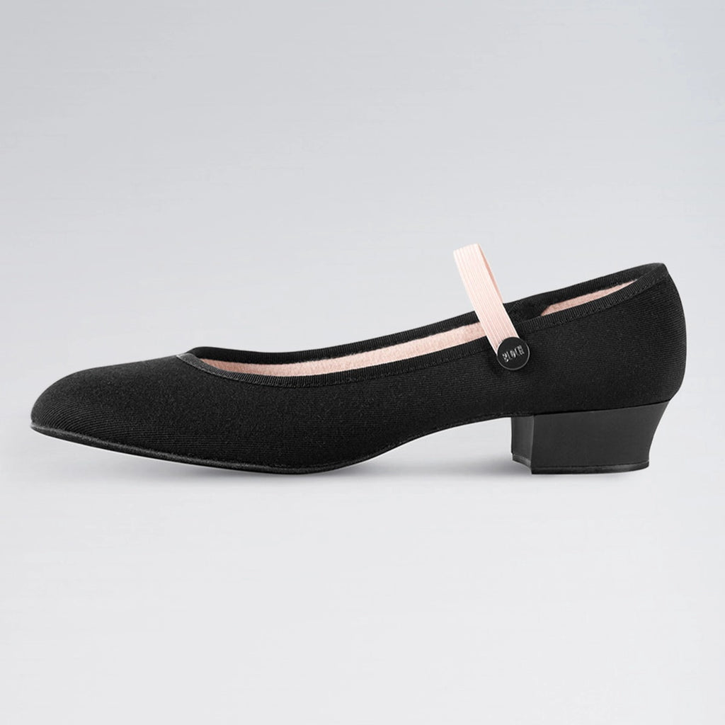 Black shoe with a strap on a light gray background