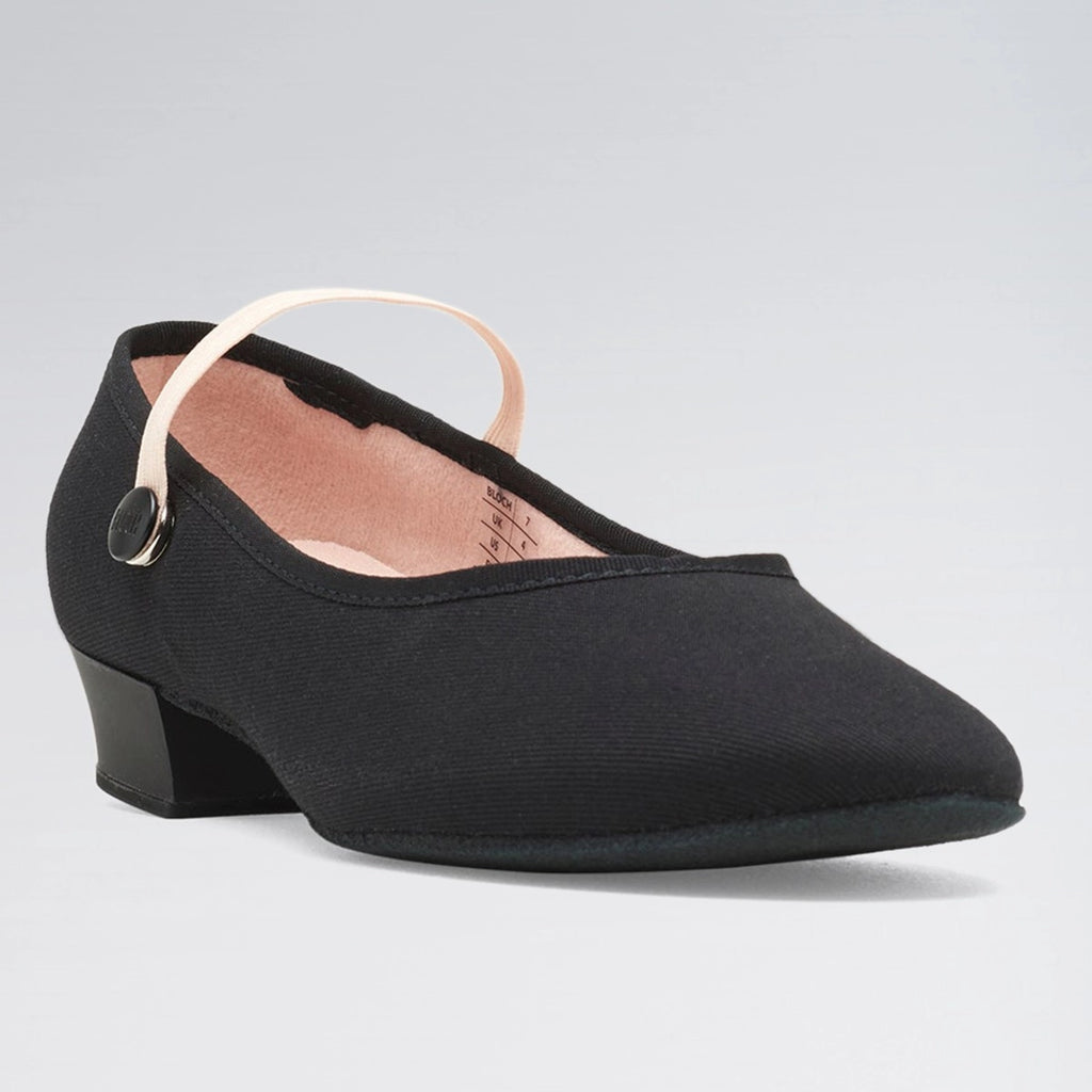 Black shoe with a small heel on a light gray background
