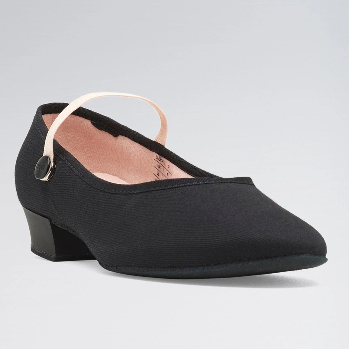 Black shoe with a small heel on a light gray background