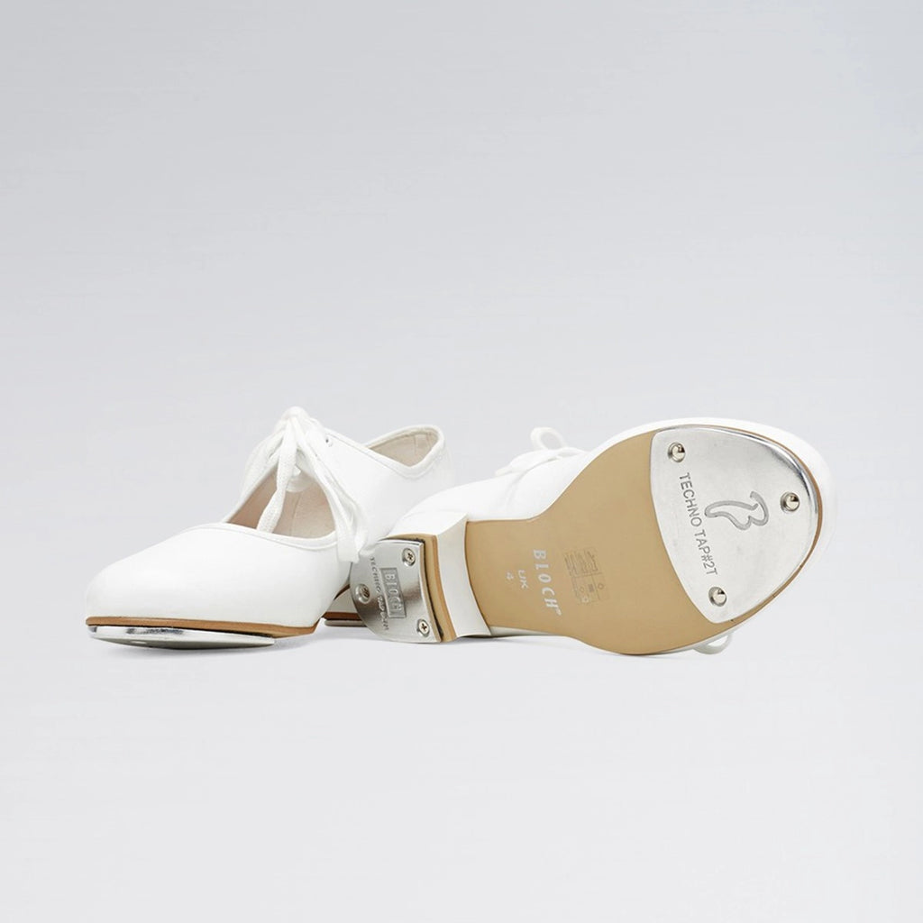 White tap shoe with metallic toe on a light gray background