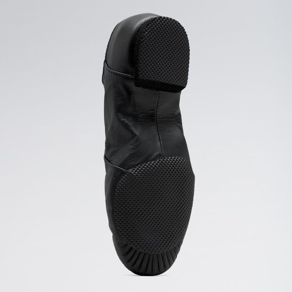 Black rain boot with a textured sole on a light gray background