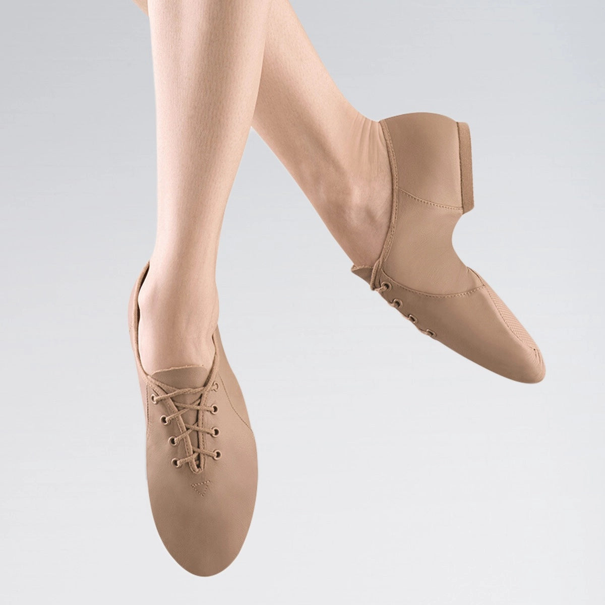 Beige dance shoes worn with a neutral background