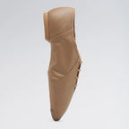Brown leather shoe on a light gray background