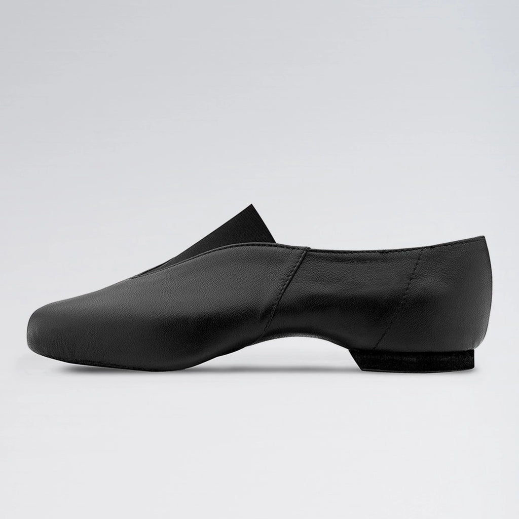 Black dance shoe on a light gray background