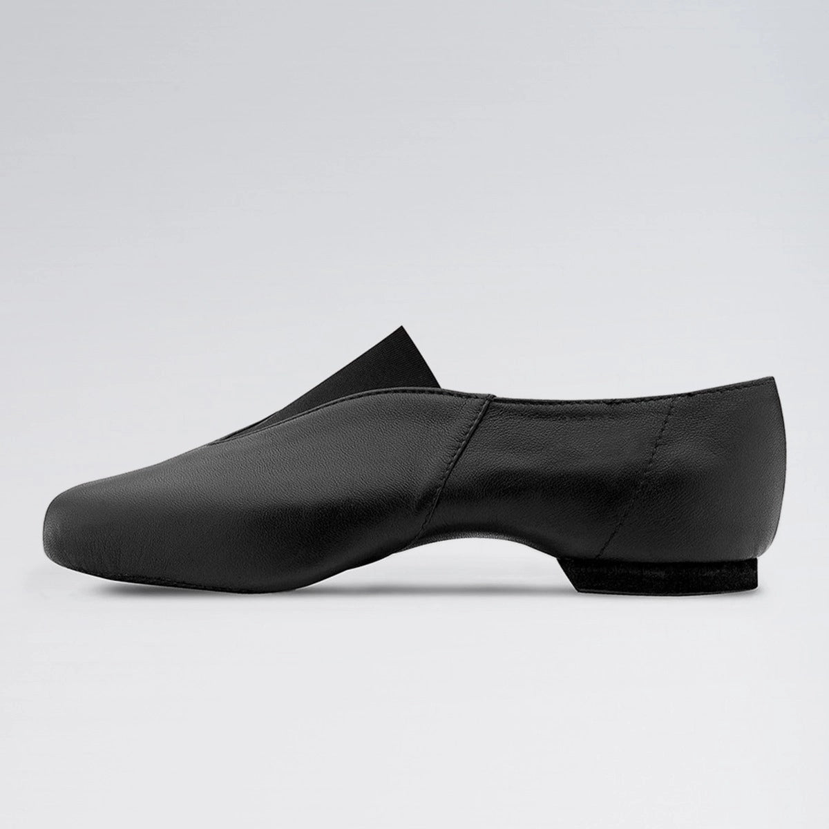 Black dance shoe on a light gray background