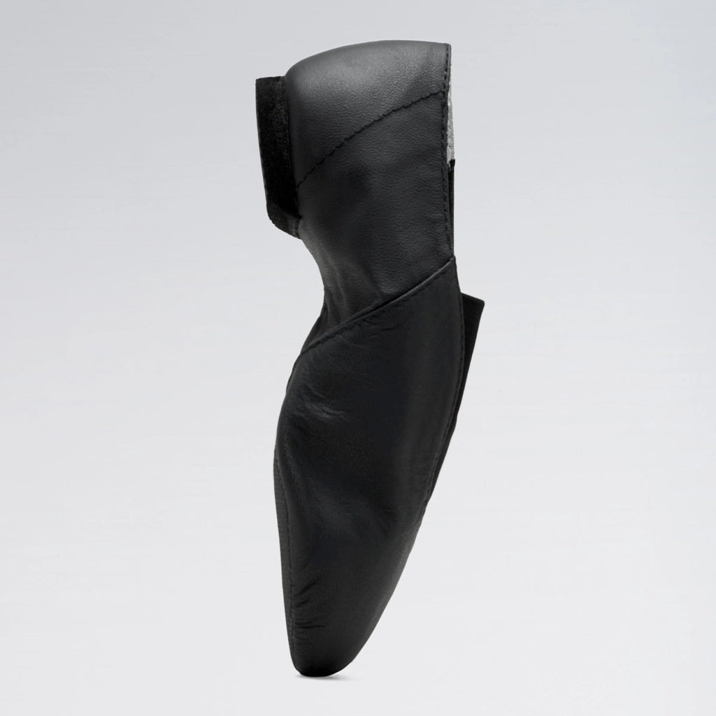 Black leather shoe on a light gray background