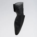 Black leather shoe on a light gray background