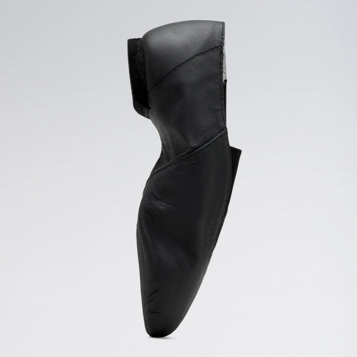 Black leather shoe on a light gray background