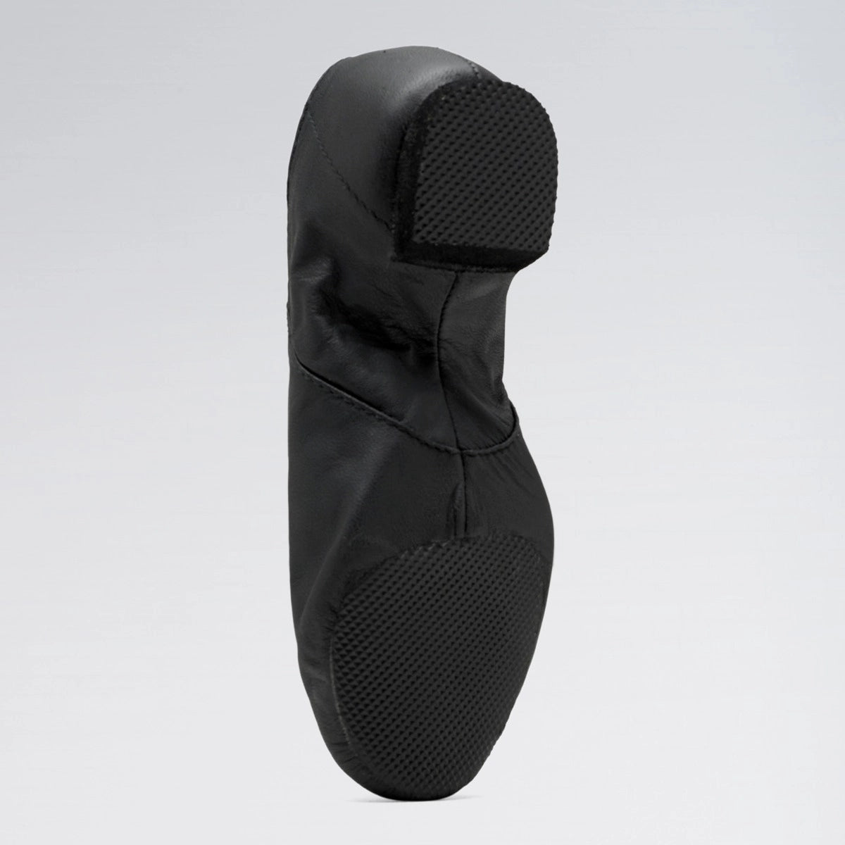 Black dance shoe on a light gray background