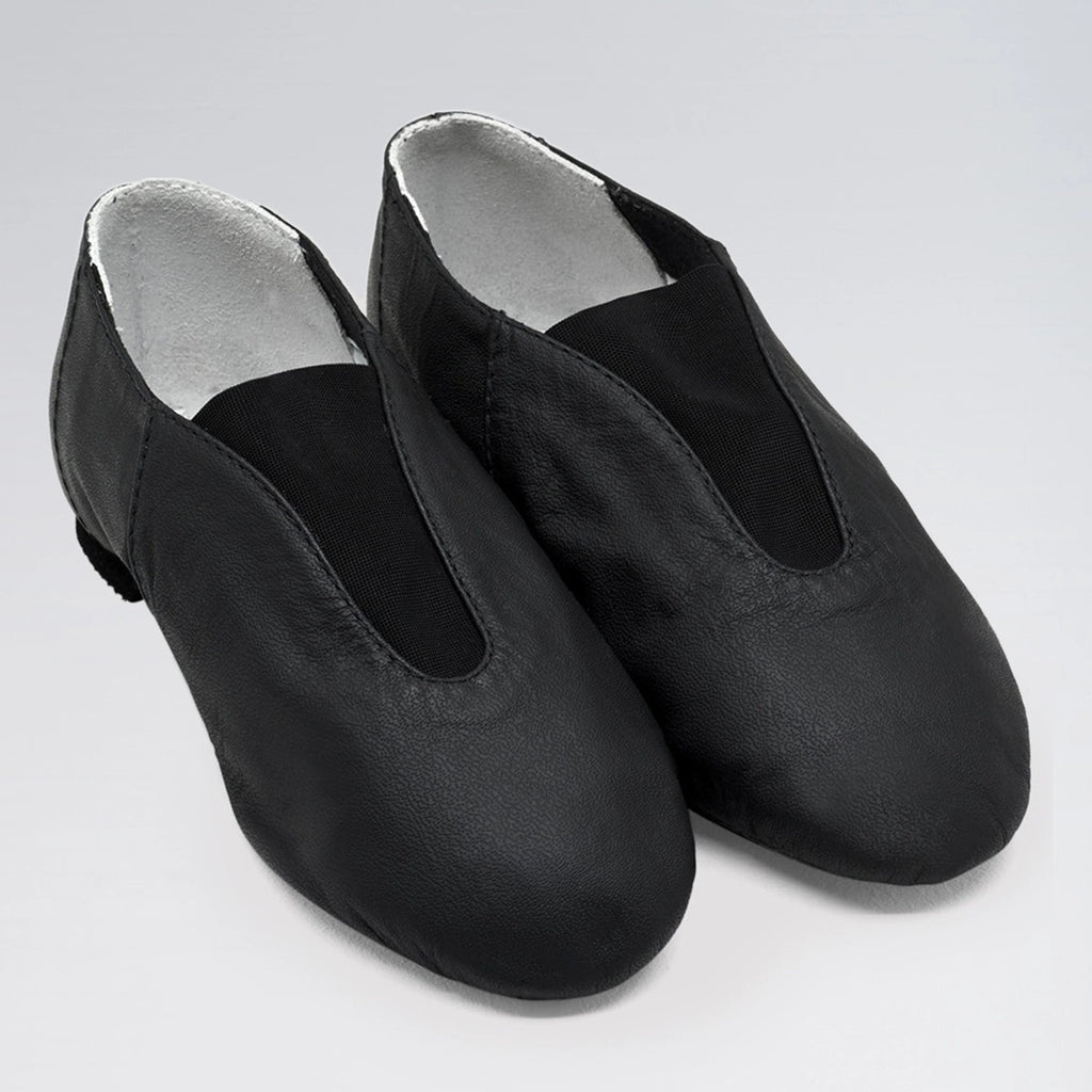 Pair of black dance shoes with silver lining on a light gray background