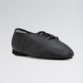 Black leather tap shoe on a light gray background