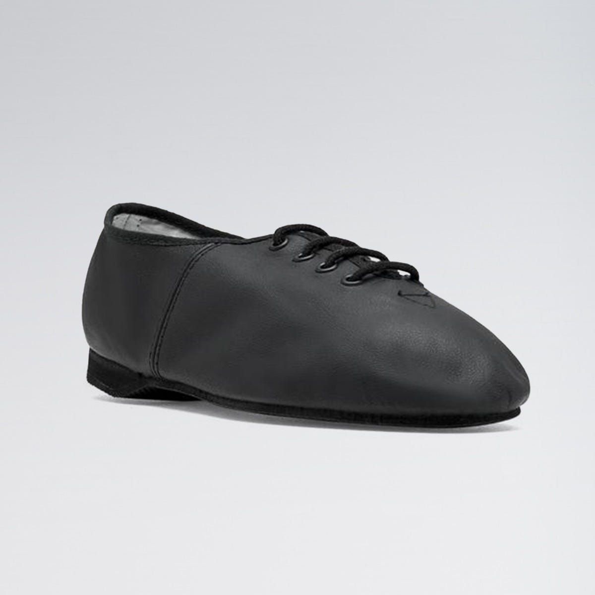 Black leather tap shoe on a light gray background