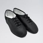 Pair of black dance shoes on a light gray background