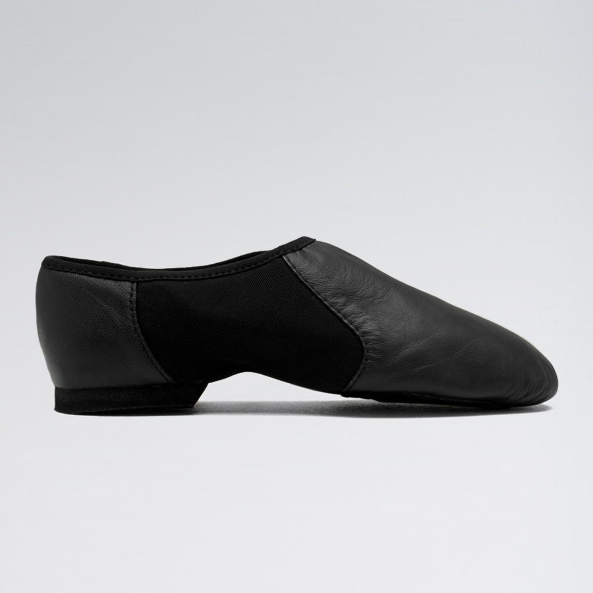 Black dance shoe on a light gray background
